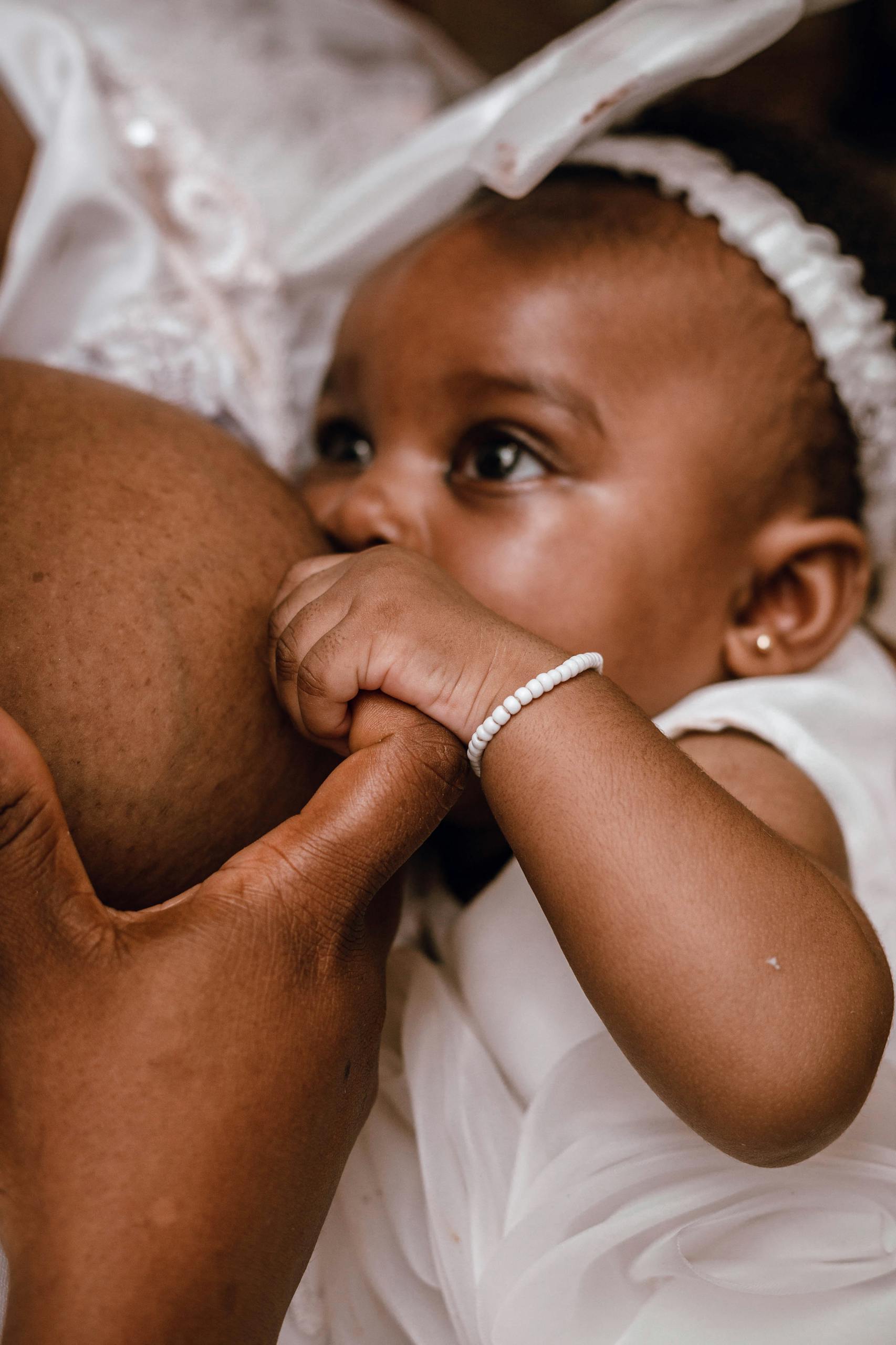 A tender moment of a mother breastfeeding her baby, symbolizing love and connection.